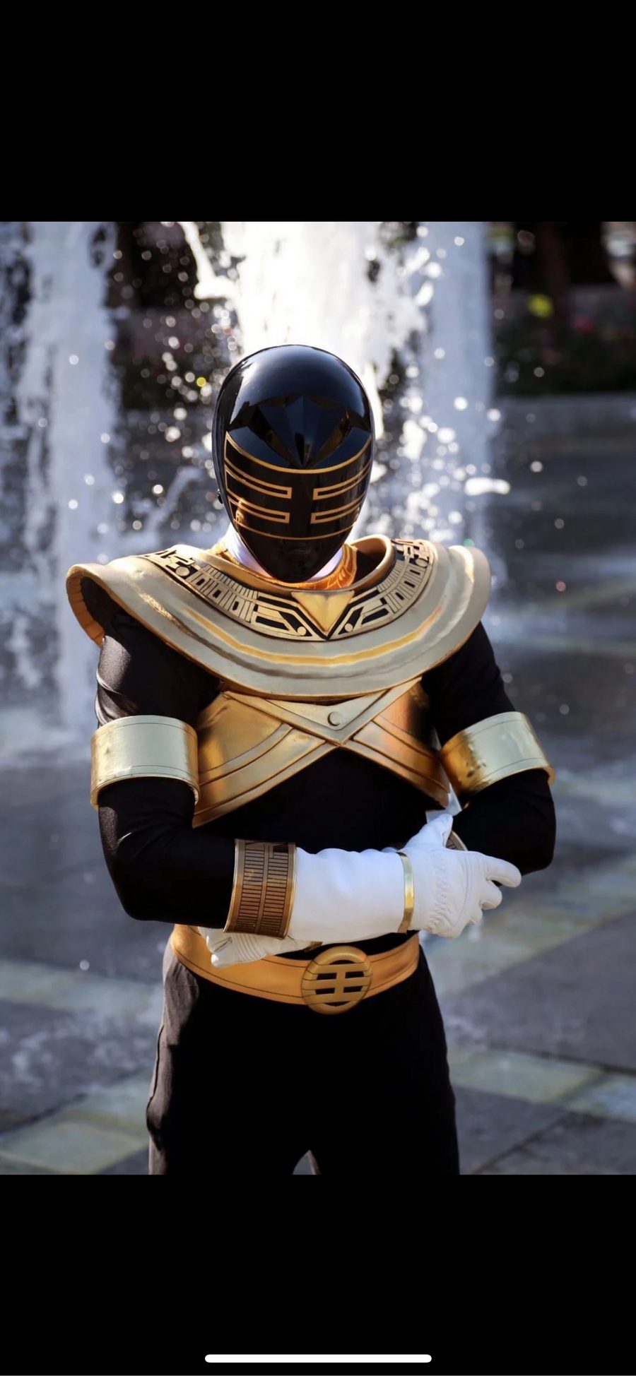 Black and gold armored warrior with helmet on, face covered