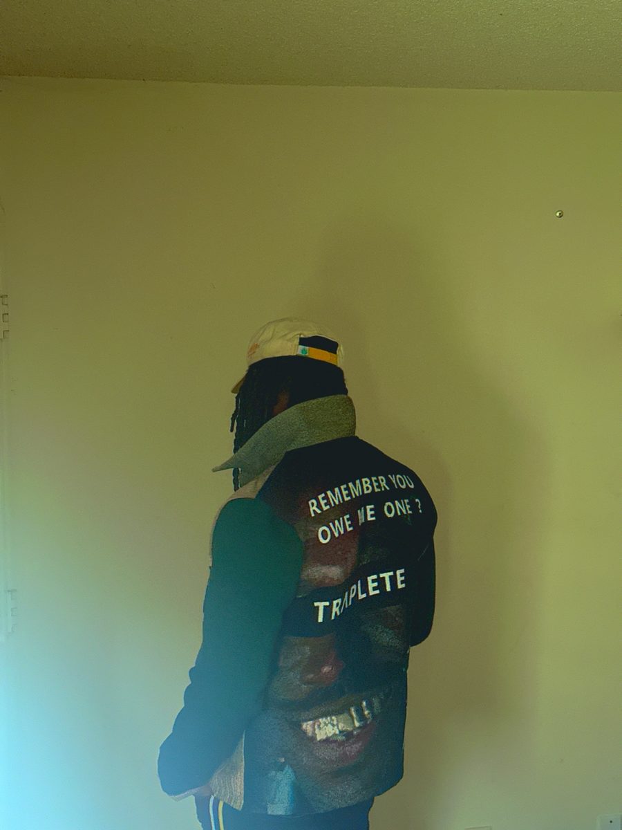 Back view of the TRAPLETE vest under green light, face hidden